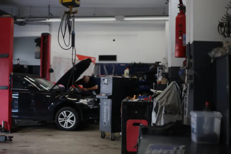 Mechanic repairing a car in an automotive workshop