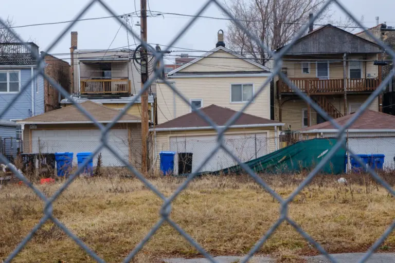 Residential properties behind a chain link security fence