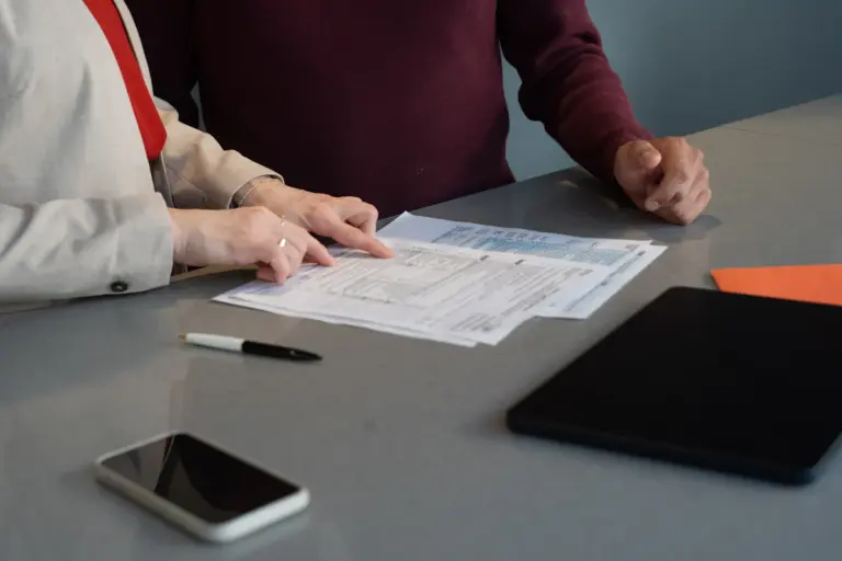 Professionals reviewing important paperwork and legal documents