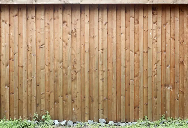 Wooden privacy fence along a residential garden