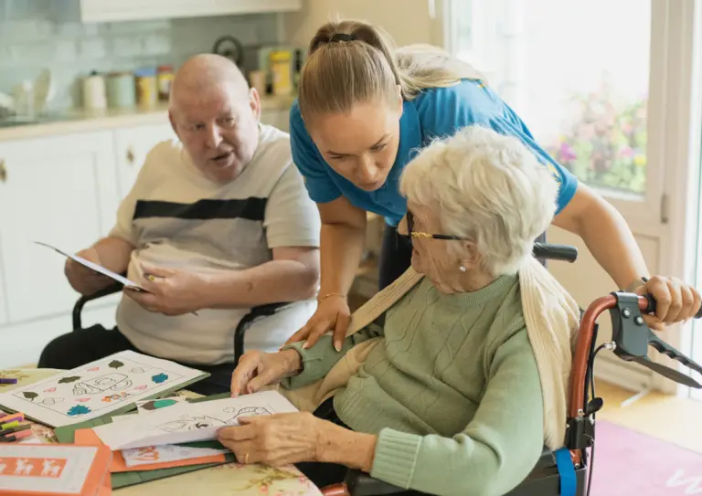 Caregiver supporting elderly nursing home residents