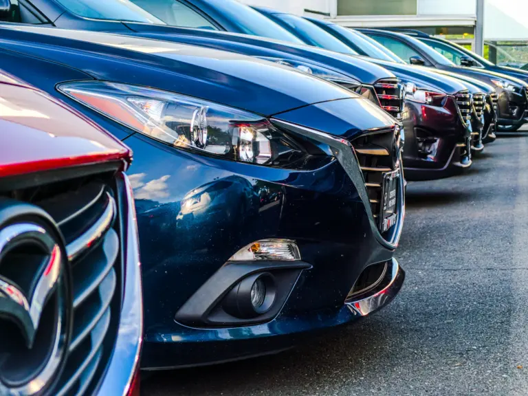 Row of cars displayed at a dealership