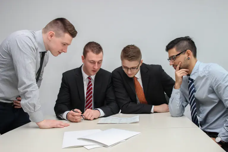 People reviewing legal paperwork during an office consultation