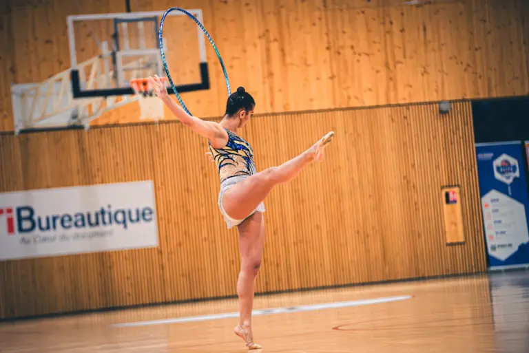 Gymnast practicing a floor routine in a gymnastics training space